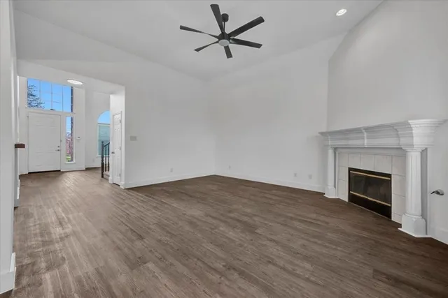 a view of a kitchen with a stove wooden floor and a ceiling fan