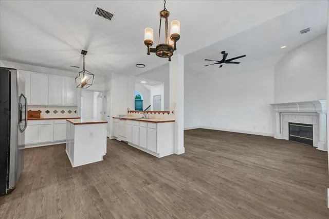 a view of a room with wooden floor air conditioner and windows