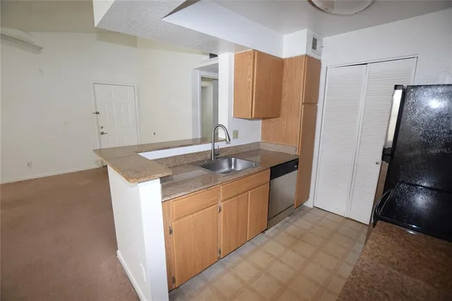 a kitchen with a sink and cabinets
