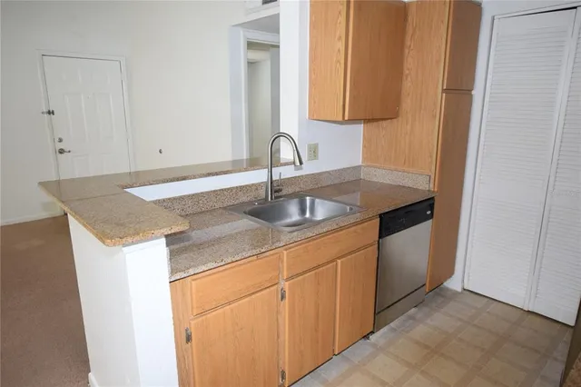 a kitchen with stainless steel appliances granite countertop a refrigerator and a stove