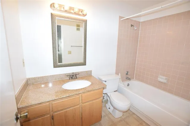 a bathroom with a bathtub shower sink and toilet