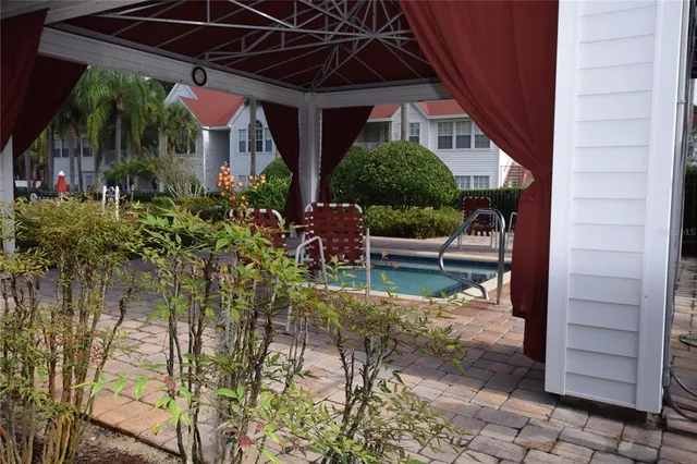a view of a chair and table in the patio