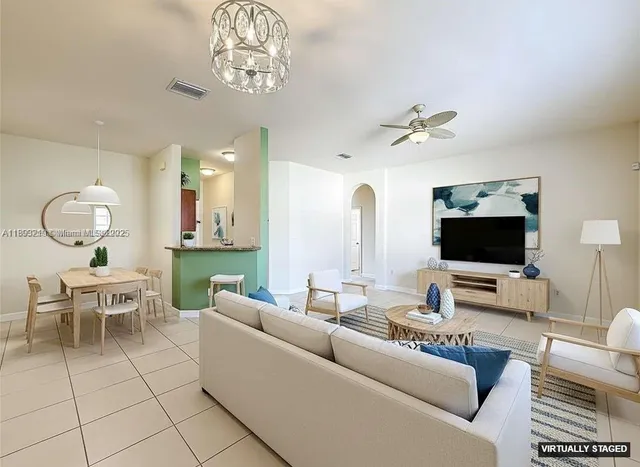 a living room with furniture and a flat screen tv