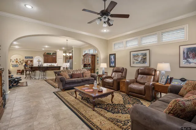 a bedroom with a large bed and a flat tv screen on dresser