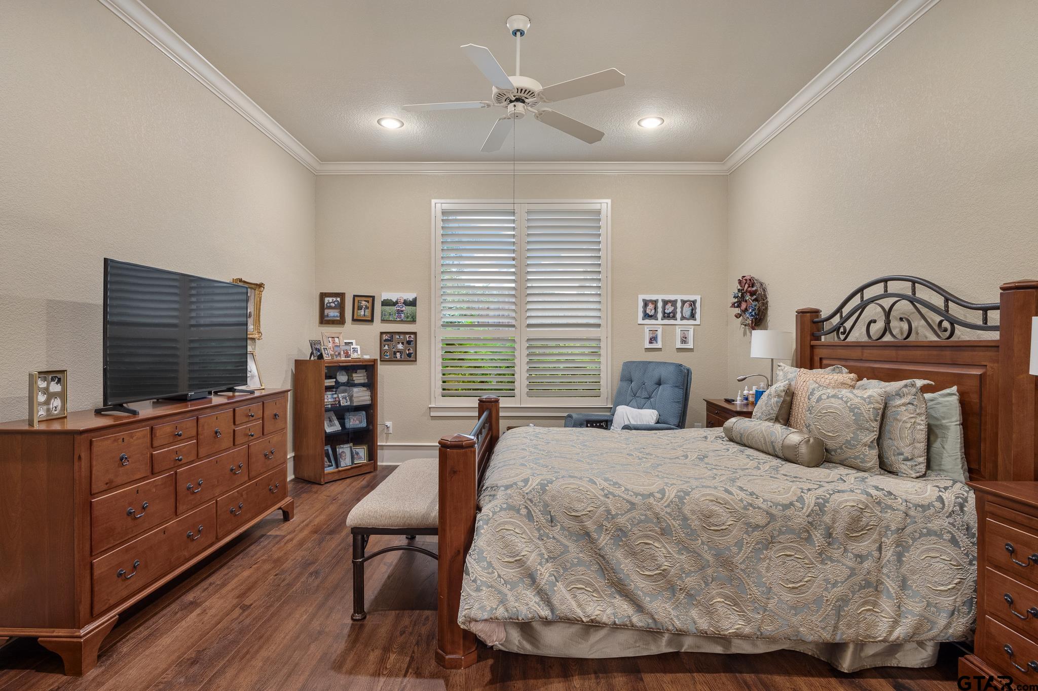 4322 Madera Drive Tyler, TX 75707 - Photo 20 of 32 a bedroom with a large bed and a flat tv screen on dresser