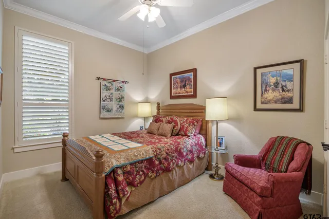 a balcony with couple of chairs and a potted plant