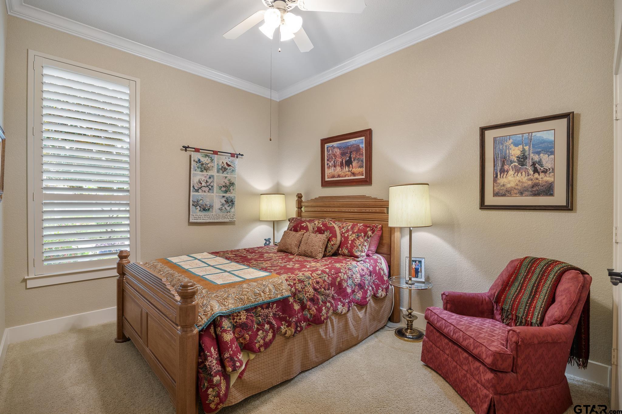 4322 Madera Drive Tyler, TX 75707 - Photo 27 of 32 a bedroom with bed and a chandelier