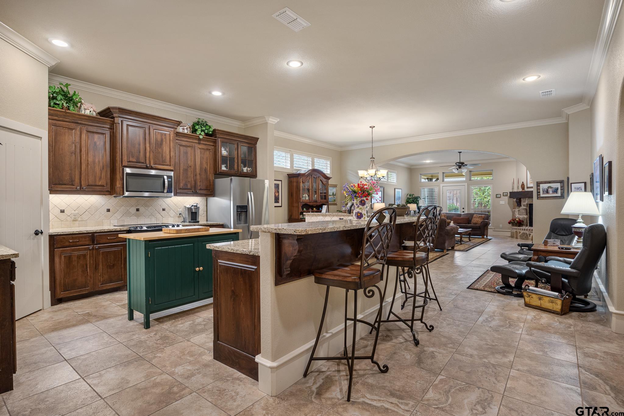 4322 Madera Drive Tyler, TX 75707 - Photo 5 of 32 a kitchen with a sink and chairs