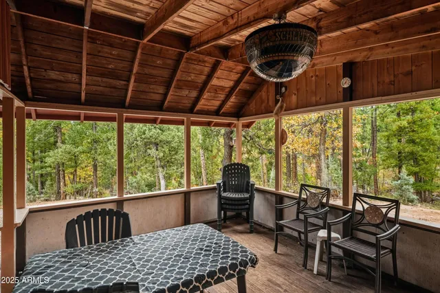 a view of a porch with furniture and a yard