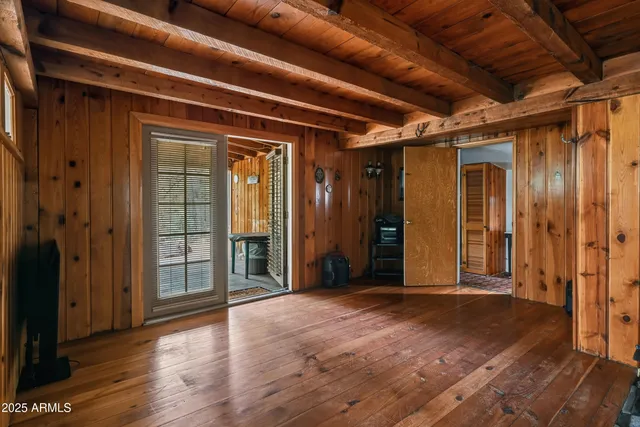 a kitchen with stainless steel appliances granite countertop a refrigerator a stove and a sink with wooden cabinets