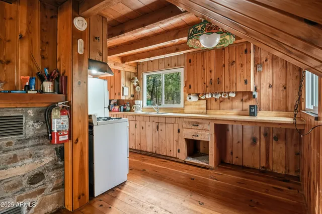 a kitchen with sink a window and refrigerator
