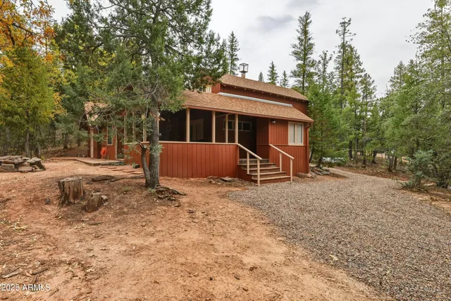 a view of a house with a yard and roof