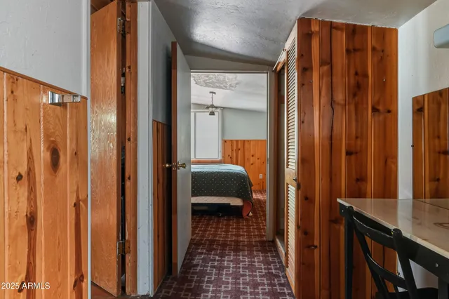 a view of a bedroom with wooden floor and closet
