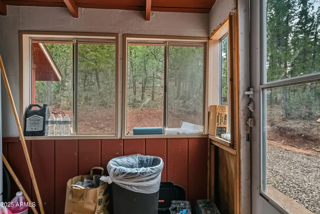 an aerial view of a house with a yard and large trees