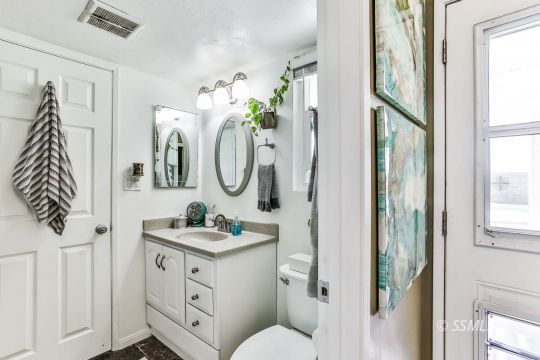 429 West Perdew Avenue Ridgecrest, CA 93555 - Photo 32 of 50 a bathroom with a toilet sink and mirror