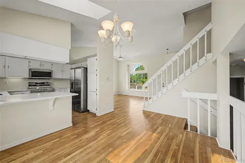 a view of entryway and kitchen with wooden floor