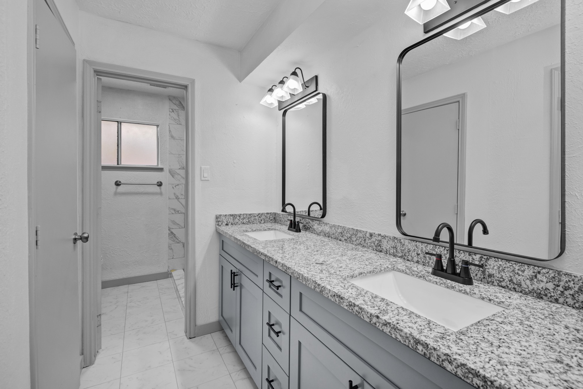 13747 Rampchester Lane Houston, TX 77015 - Photo 20 of 24 a bathroom with a granite countertop sink and a mirror