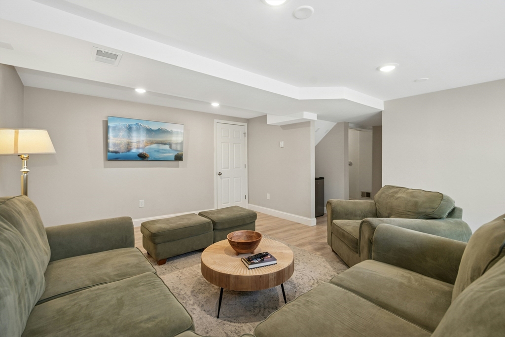 58 South Mill Street Hopkinton, MA 01748 - Photo 24 of 34 a living room with furniture and a potted plant