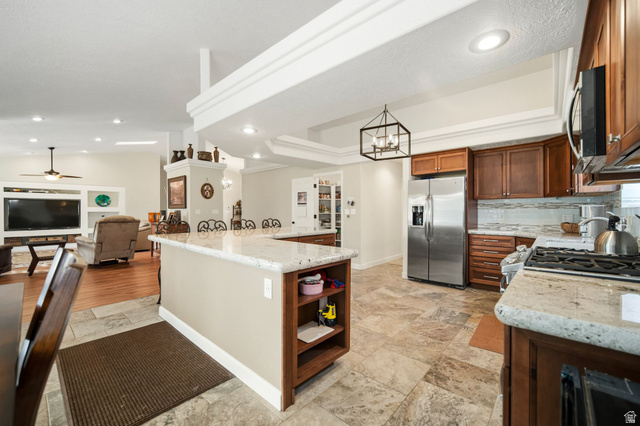 1985 West Rivers Edge Lane St. George, UT 84770 - Photo 41 of 42 Kitchen with a spacious island, light stone countertops, stainless steel appliances, ceiling fan, and open floor plan