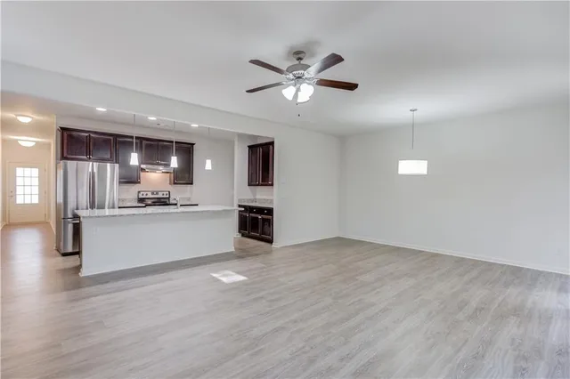 a view of a kitchen with wooden floor and a kitchen
