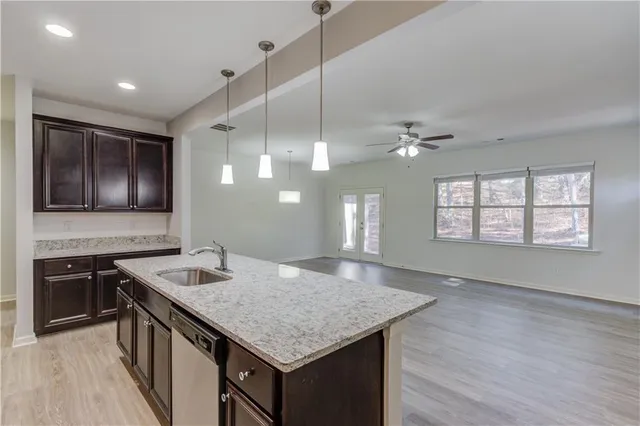 a kitchen with kitchen island a sink appliances and a counter top space