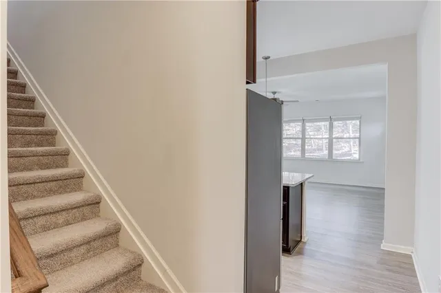 a view of entryway and hall with wooden floor