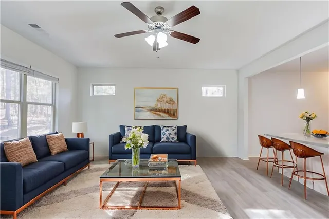 a living room with furniture a rug and a window