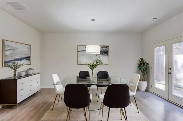 a view of a dining room with furniture wooden floor and chandelier