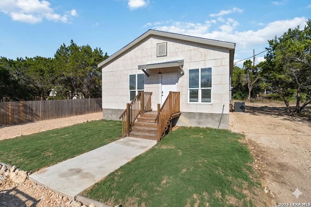 a front view of a house with yard and green space