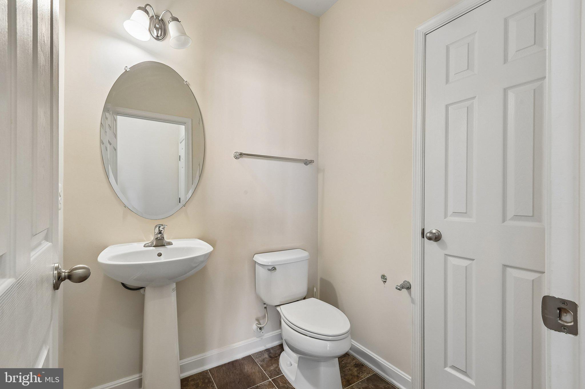 9581 Center Street Manassas, VA 20110 - Photo 14 of 25 a bathroom with a toilet sink and mirror