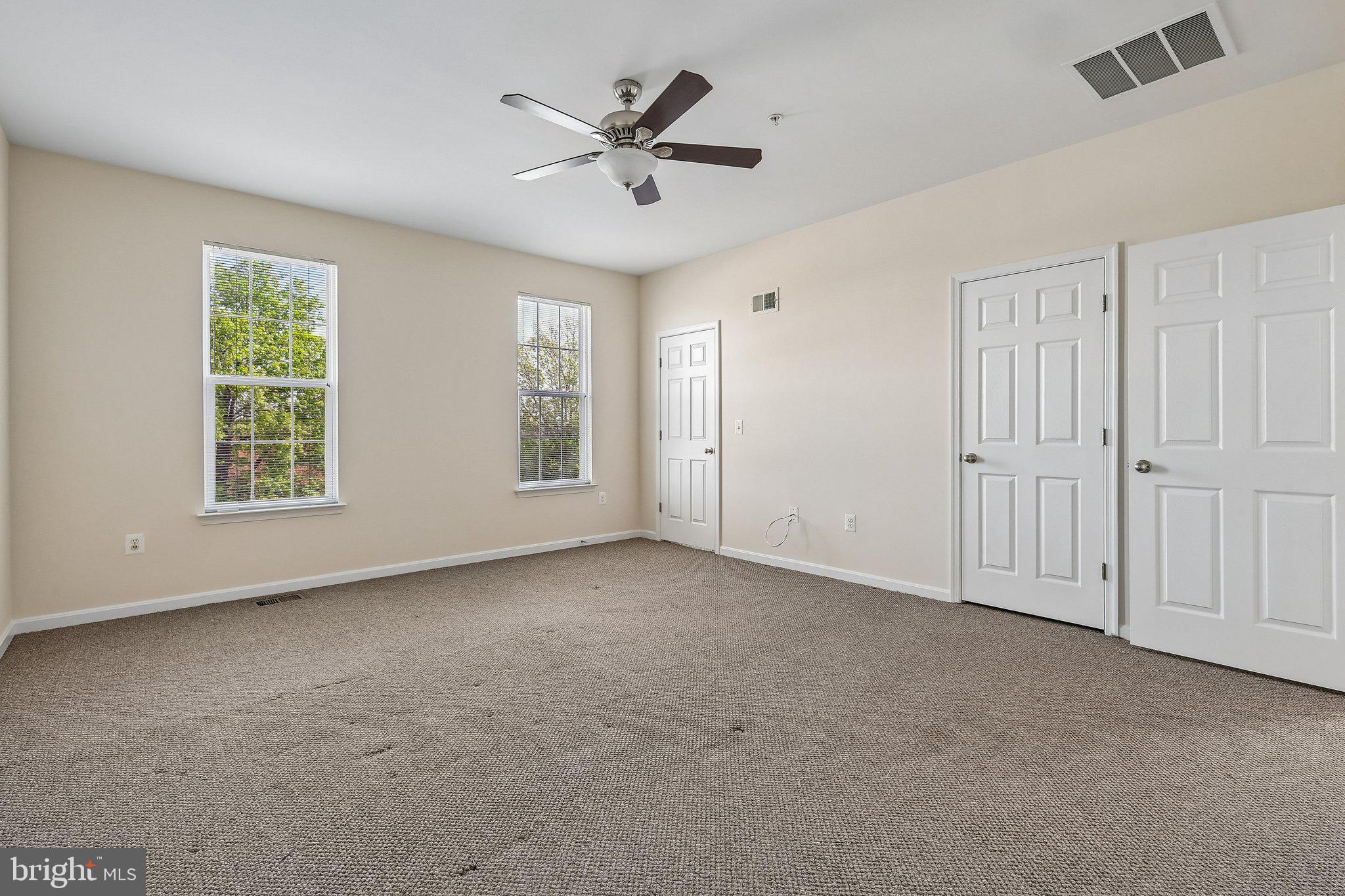 9581 Center Street Manassas, VA 20110 - Photo 16 of 25 an empty room with windows and ceiling fan