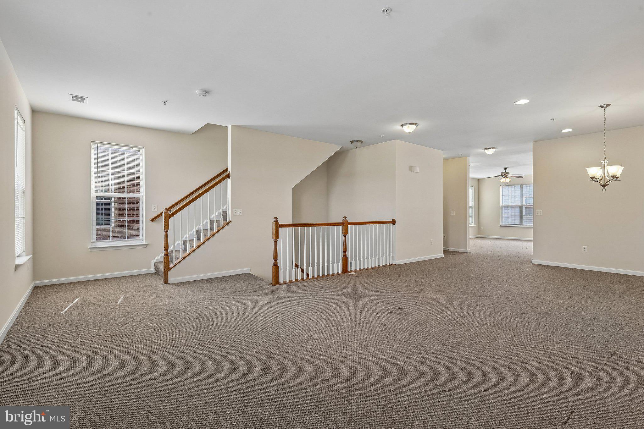 9581 Center Street Manassas, VA 20110 - Photo 2 of 25 a view of an empty room with stairs and a window