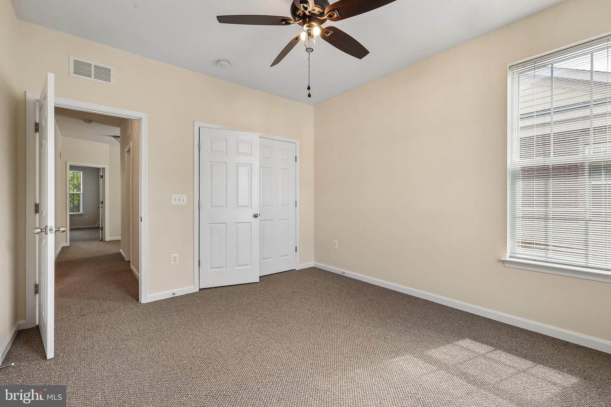 9581 Center Street Manassas, VA 20110 - Photo 23 of 25 an empty room with chandelier fan and windows