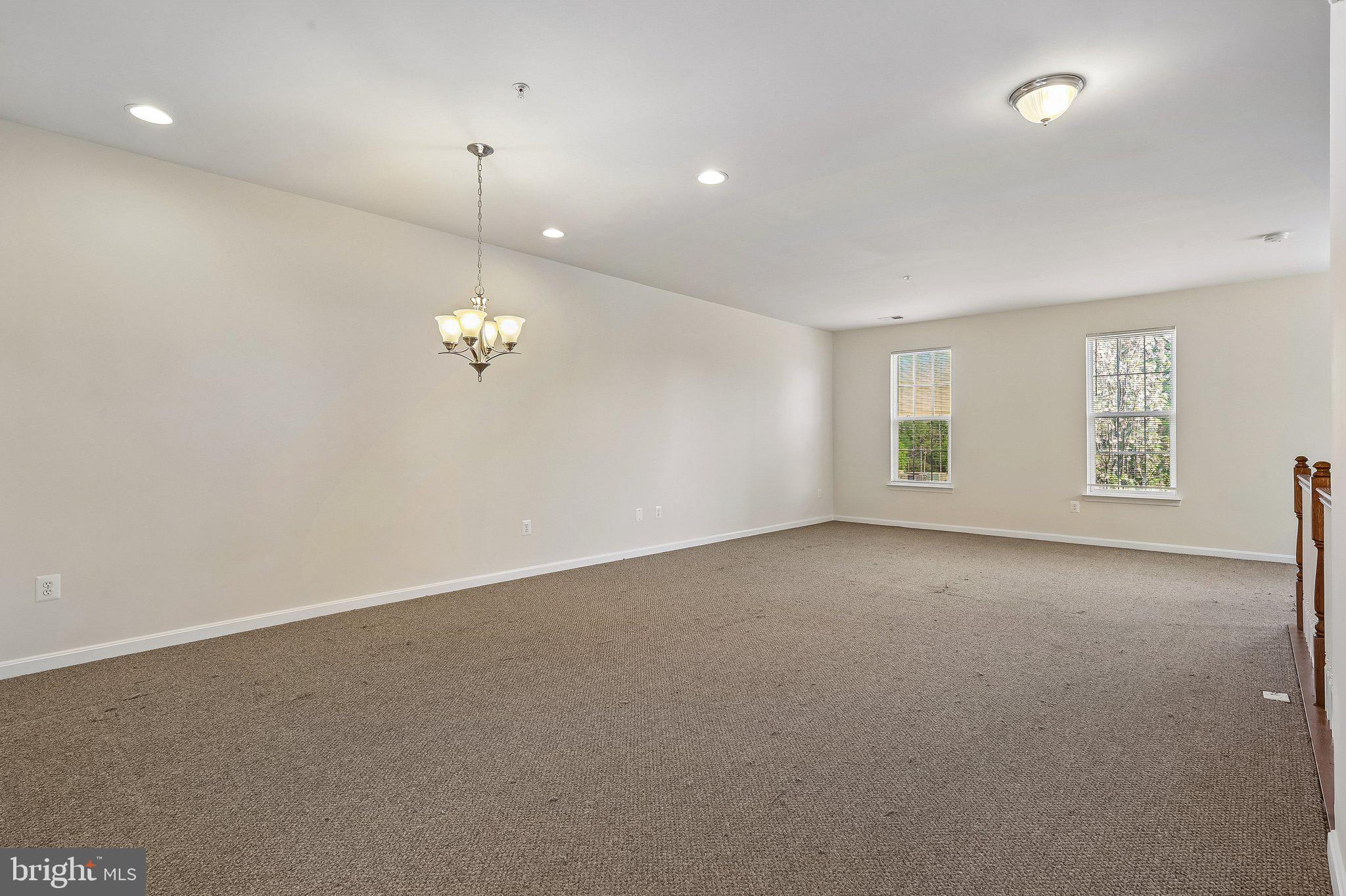 9581 Center Street Manassas, VA 20110 - Photo 3 of 25 an empty room with windows and ceiling fan