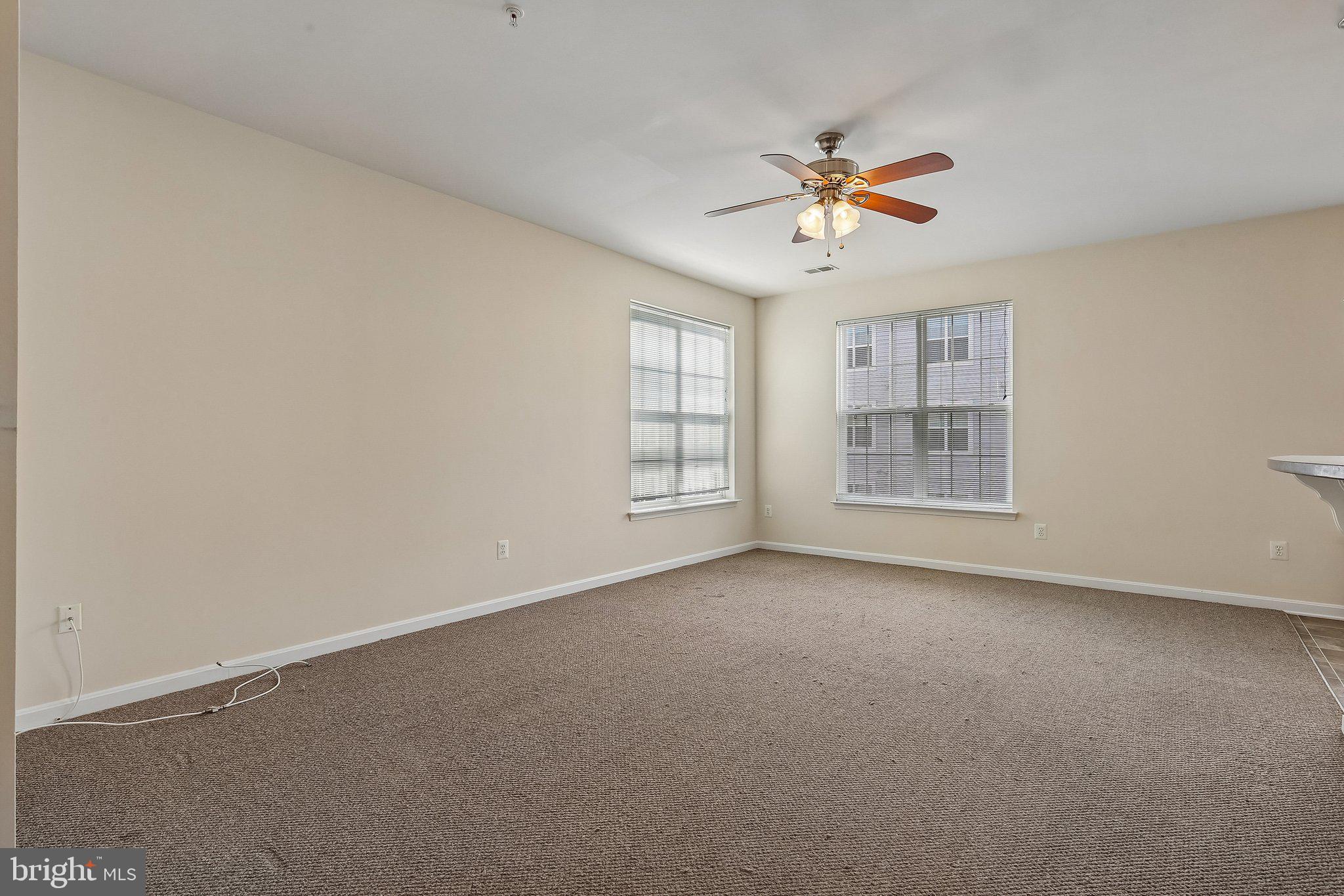 9581 Center Street Manassas, VA 20110 - Photo 6 of 25 an empty room with windows and ceiling fan