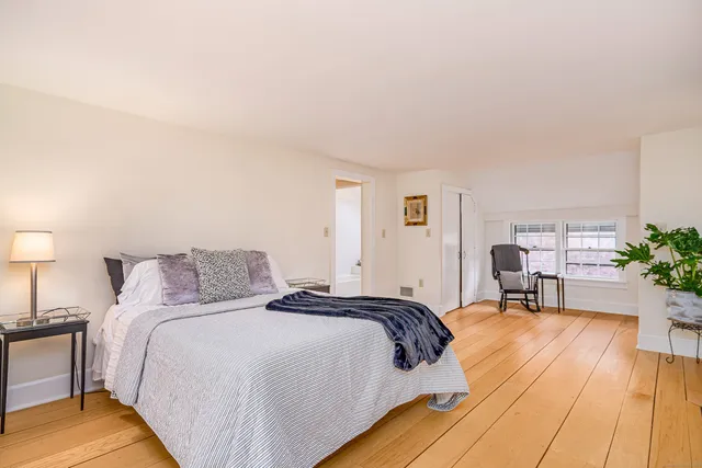 a bed room with a bed and a chair