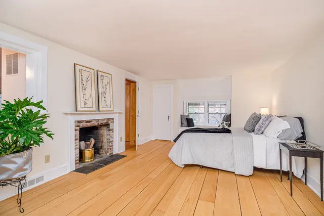 a bedroom with a bed and a fireplace