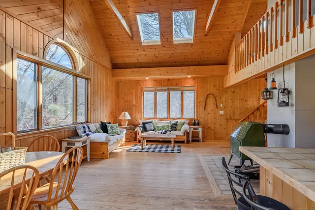 a living room with furniture and large windows