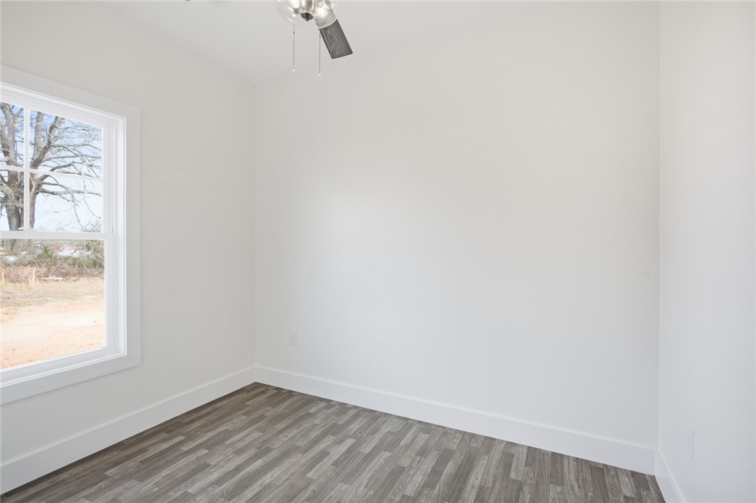 115 Riley Street Westminster, SC 29693 - Photo 18 of 46 Bright and airy room with a window providing natural light and durable flooring.