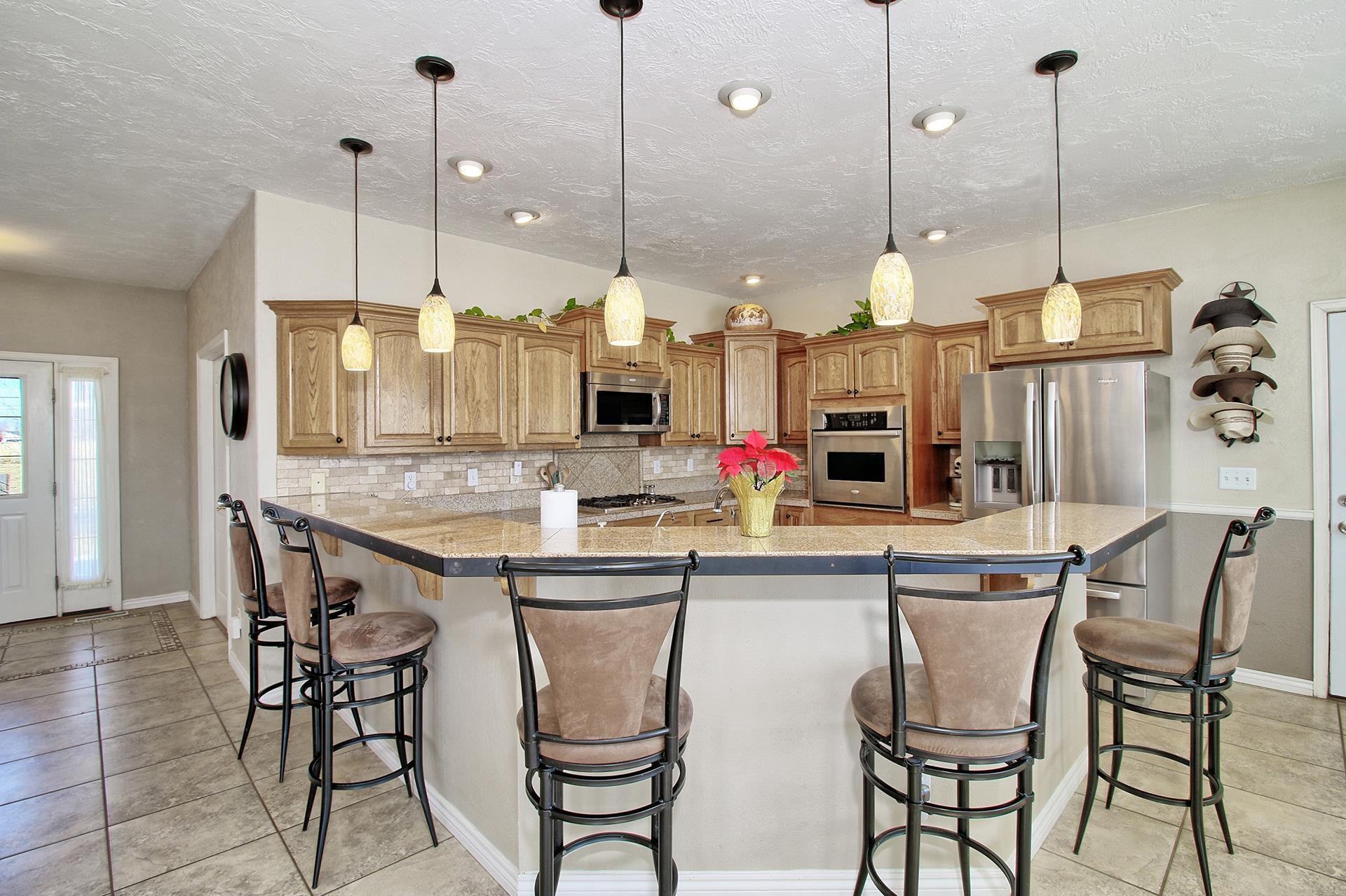 1885 J Road Fruita, CO 81521 - Photo 17 of 41 a kitchen with stainless steel appliances granite countertop a kitchen island a stove and a wooden floor