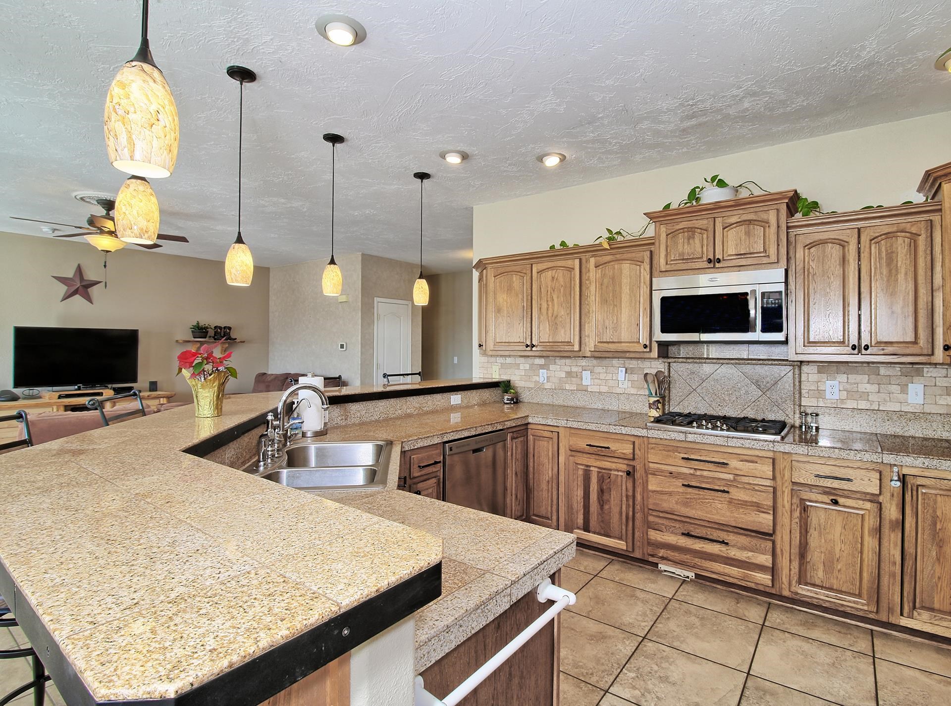 1885 J Road Fruita, CO 81521 - Photo 18 of 41 a kitchen with stainless steel appliances granite countertop a sink and white cabinets