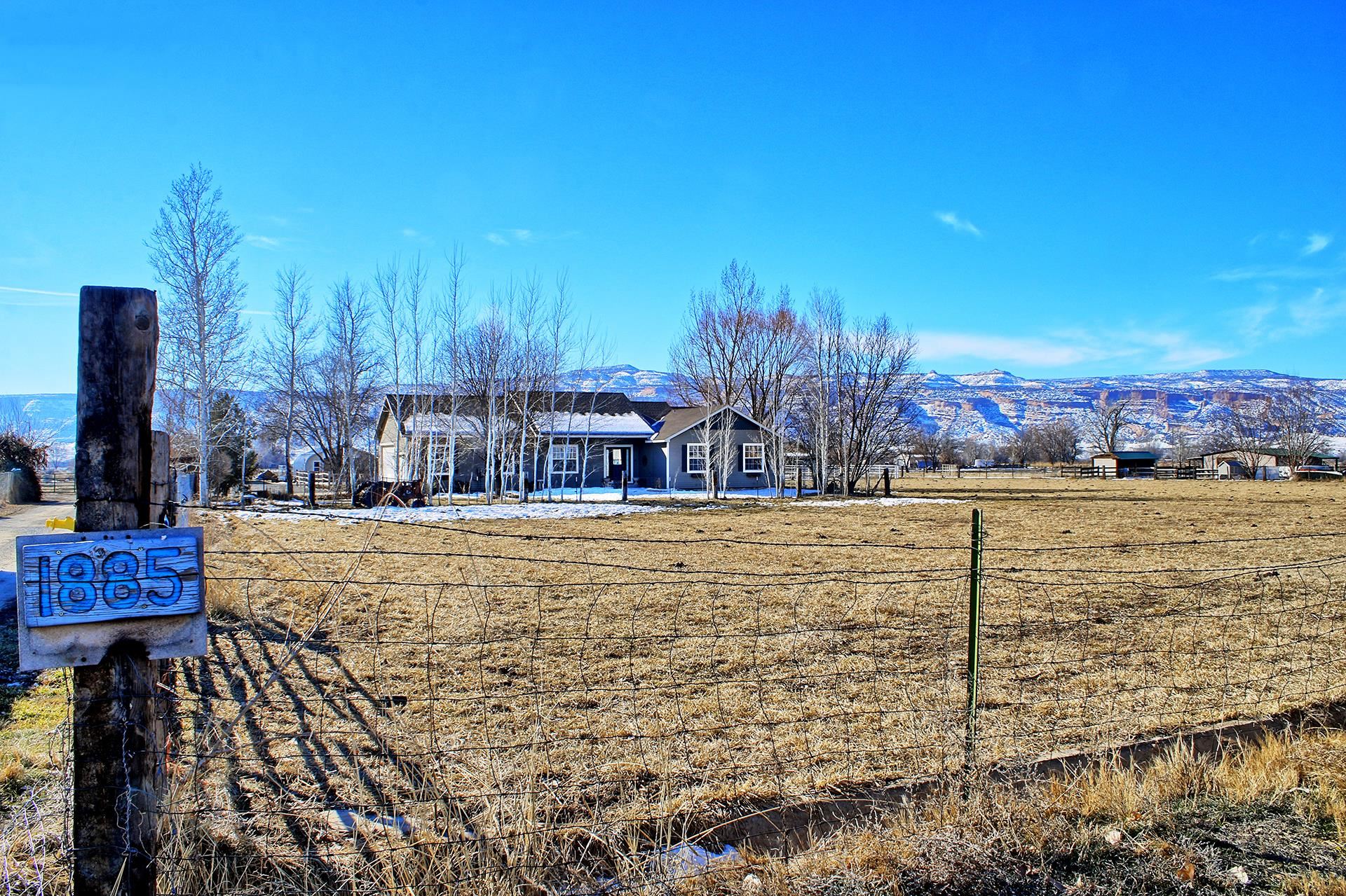 1885 J Road Fruita, CO 81521 - Photo 2 of 41 a view of a swimming pool with an outdoor seating and a pathway