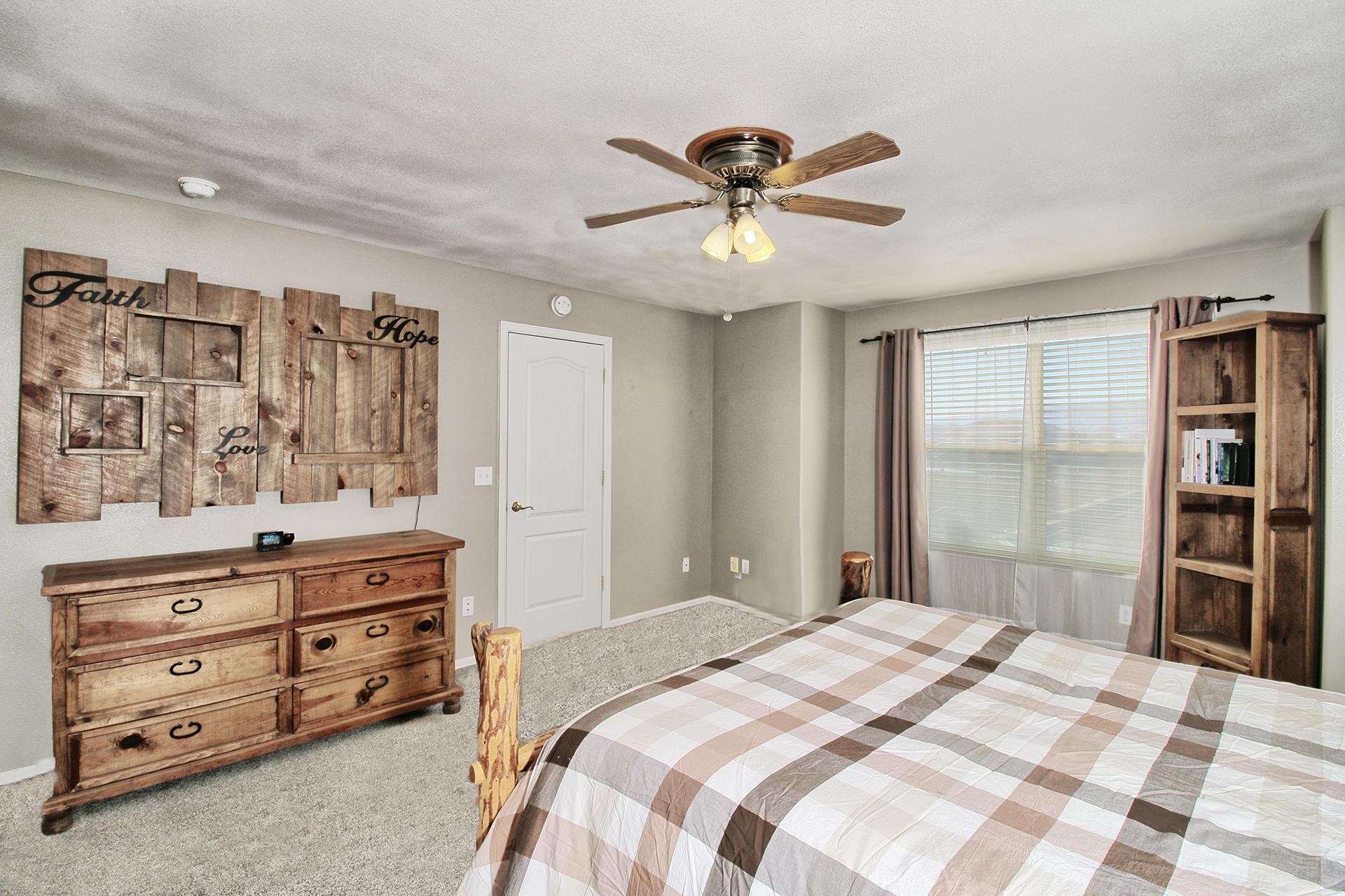 1885 J Road Fruita, CO 81521 - Photo 23 of 41 a bedroom with a bed and a chandelier