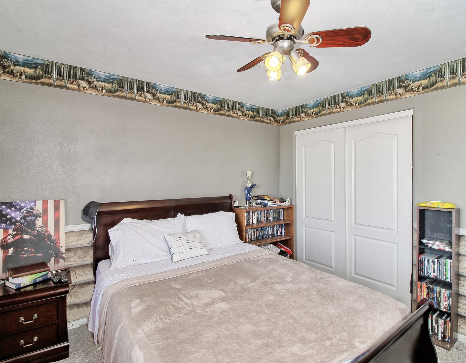 1885 J Road Fruita, CO 81521 - Photo 26 of 41 a bedroom with a bed and a chandelier