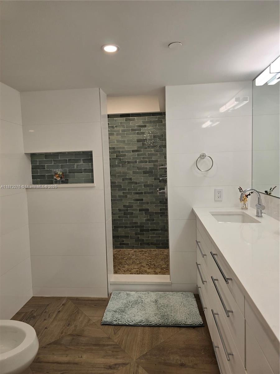 Millionaire's Row Miami Beach, FL 33140 - Photo 20 of 34 a bathroom with a granite countertop sink a toilet and shower