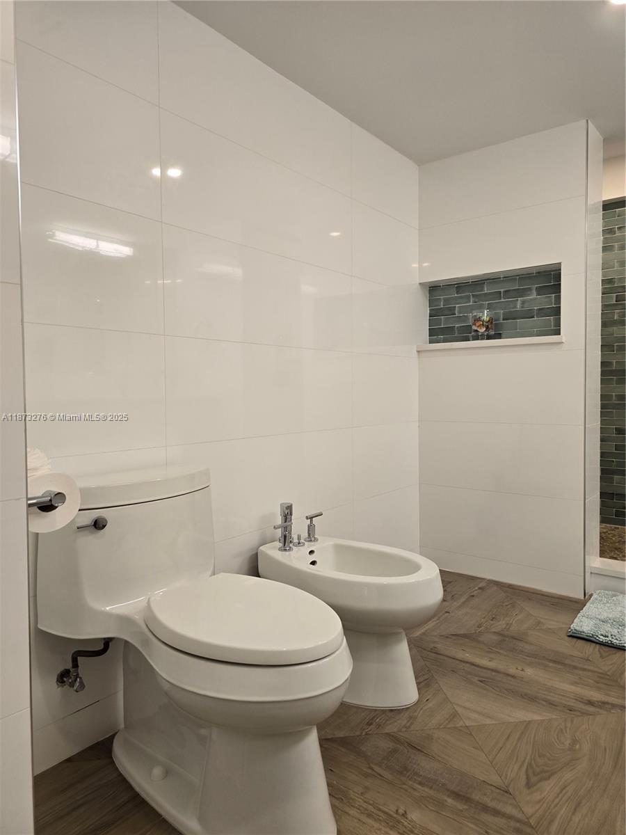 Millionaire's Row Miami Beach, FL 33140 - Photo 21 of 34 a white toilet sitting next to a bathroom sink