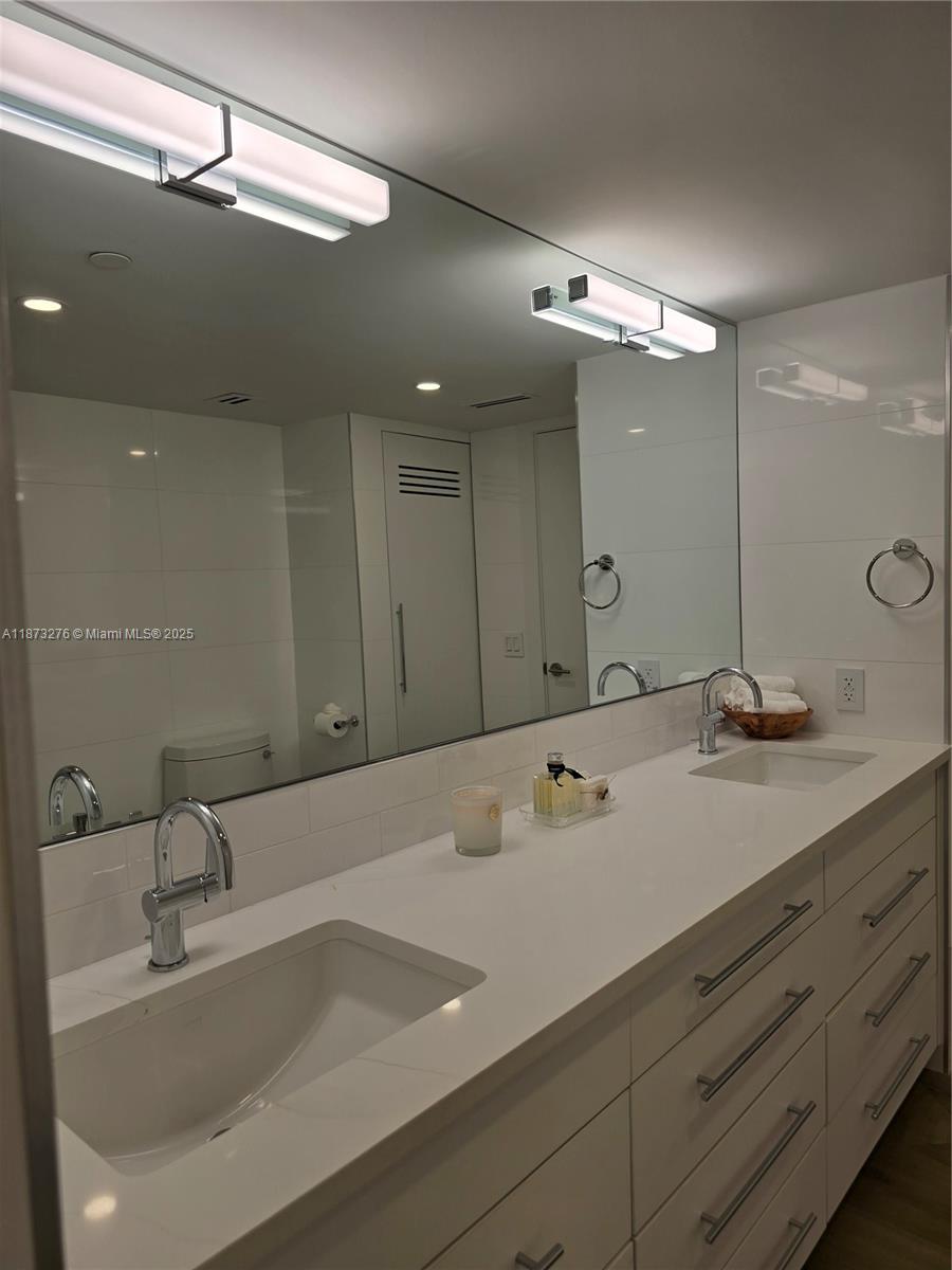 Millionaire's Row Miami Beach, FL 33140 - Photo 22 of 34 a bathroom with a sink and a mirror