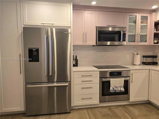 a kitchen with a refrigerator stove and microwave