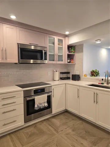 a kitchen with a stove and a microwave
