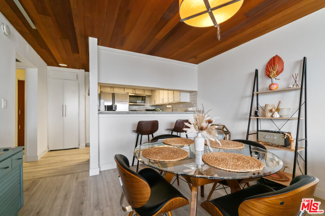6209 Pacific Avenue, Unit 103 Playa del Rey, CA 90293 - Photo 11 of 40 a view of a dining room with furniture and wooden floor